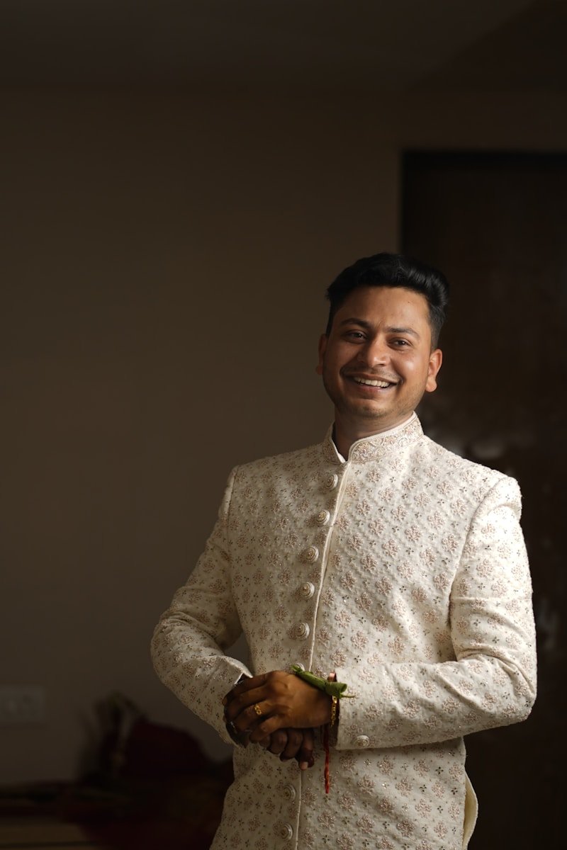 a man in a white sherve with a smile on his face